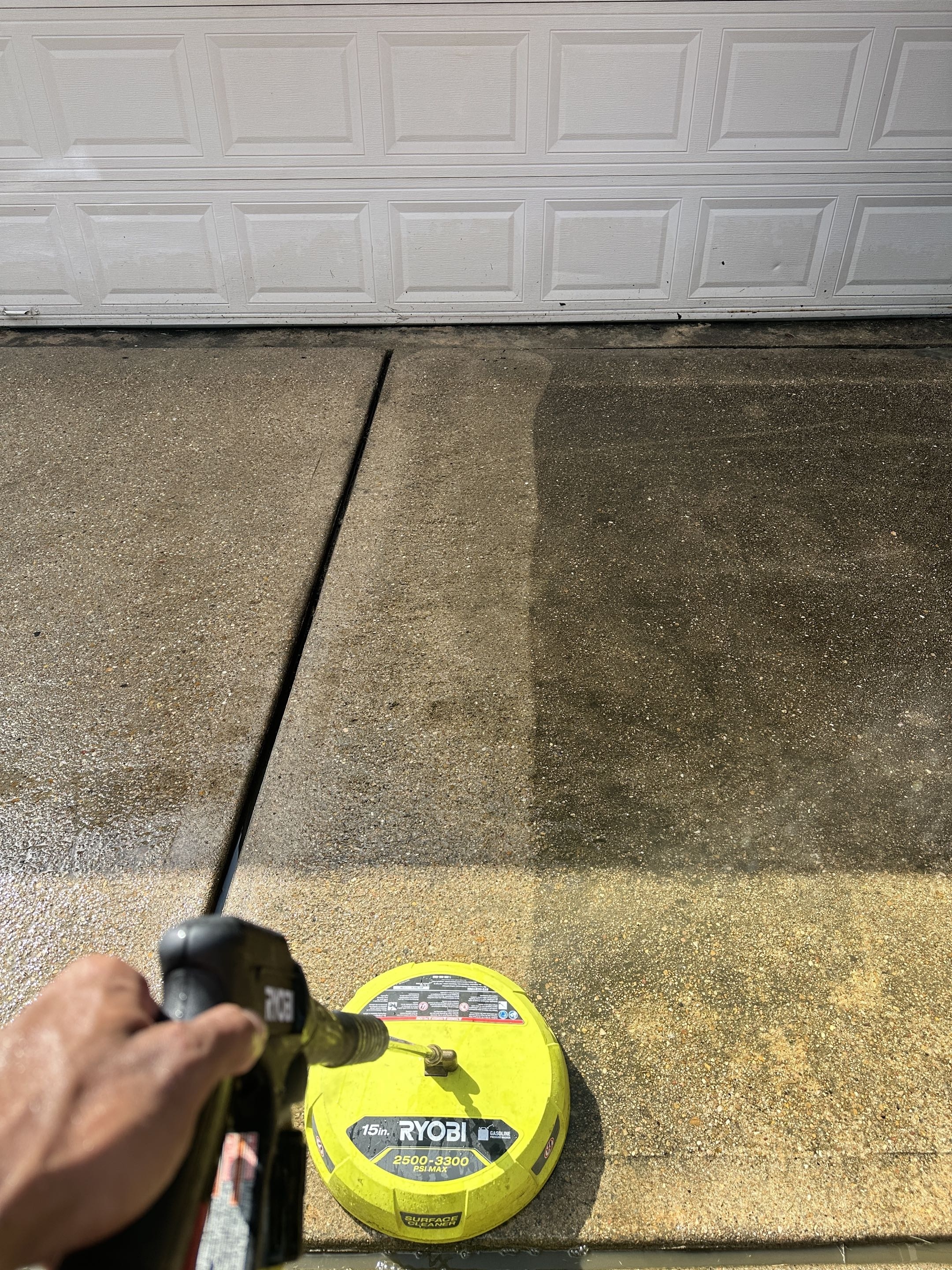 Driveway before pressure washing — stained concrete being cleaned in Cypress TX